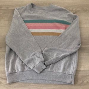 A gray crewneck with colourful stripes